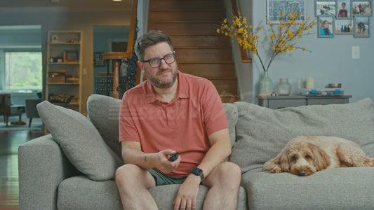 Man on Couch Finishes Watching a Movie About an Orangutan Who Plays Football and Pretends He Is the Orangutan from the Movie