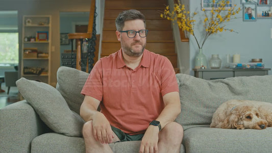 Man on Couch Feels the Top of His Head Because He's Worried He Has a Tick