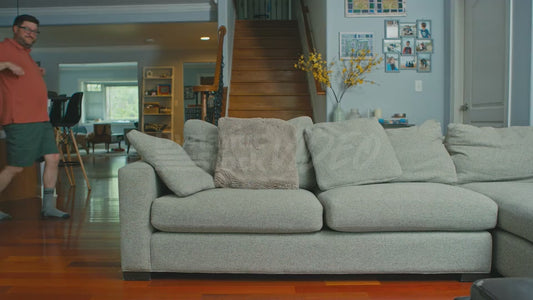 Man Takes Couch Cushions Off the Couch While Doing a Little Dance