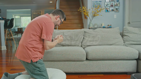 Man Kneels Before His Couch God
