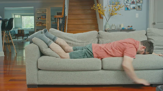 Man on Couch Practicing His Swim Technique