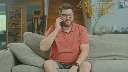 Man on Couch Talks on the Phone to Disgraced Former Texas Representative Tom DeLay