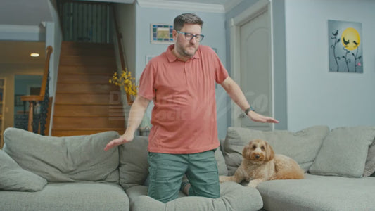 Man on Couch Dances in a Sensual Way While Kneeling