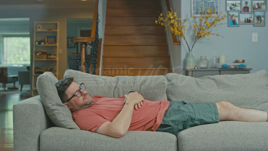 Man Sleeping on Couch but His Legs Are Going Wild