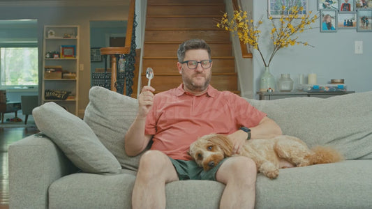 Man on Couch Holding Spoon