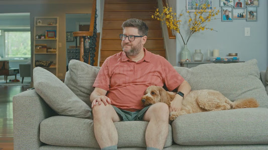 Man on Couch Touching His Shoes