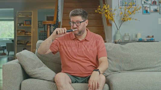 Man on Couch Brushing Teeth