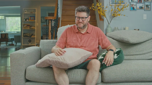 Man on Couch Really Upset by Disordered Pillows