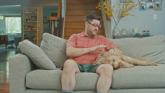 Man on Couch with Upside Down Glasses