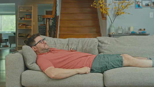 Man Lying on Couch with Small Bowl on His Stomach