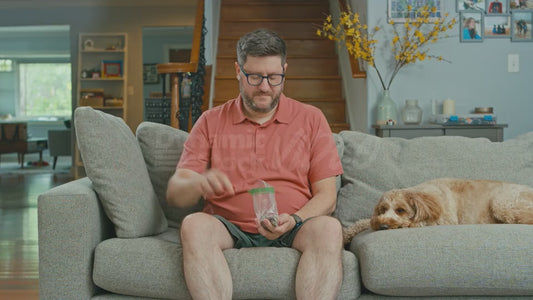 Man on Couch Puts Coins on the Couch Cushions